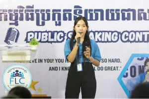 sok sophary Sok Sophary speaking into a microphone and gesturing during an FLC public speaking contest.